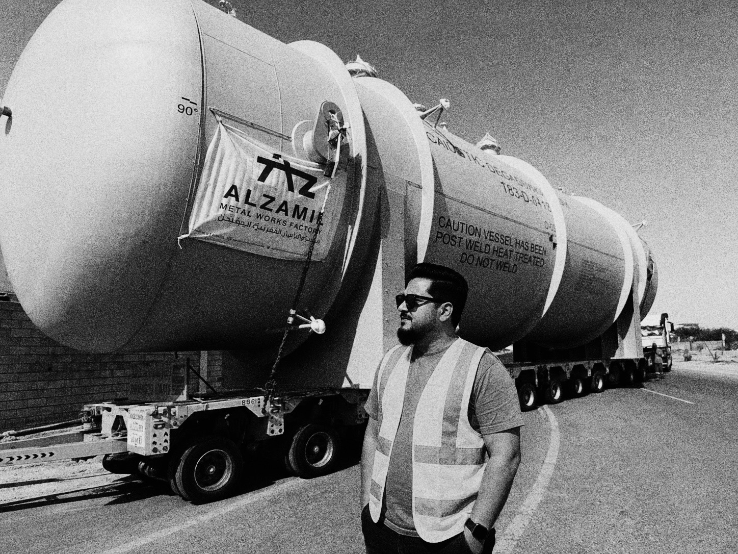 Hasan Kibria beside a loaded heavy transport convoy